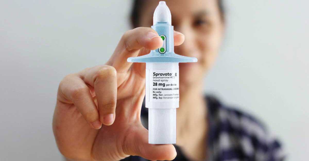 A woman holds the Spravato nasal spray treatment.