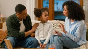 A Family Centered Treatment Practitioner speaks to a father and his daughter