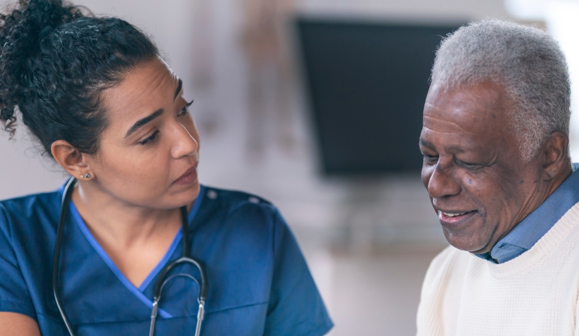 A nurse consults with an elderly patient.